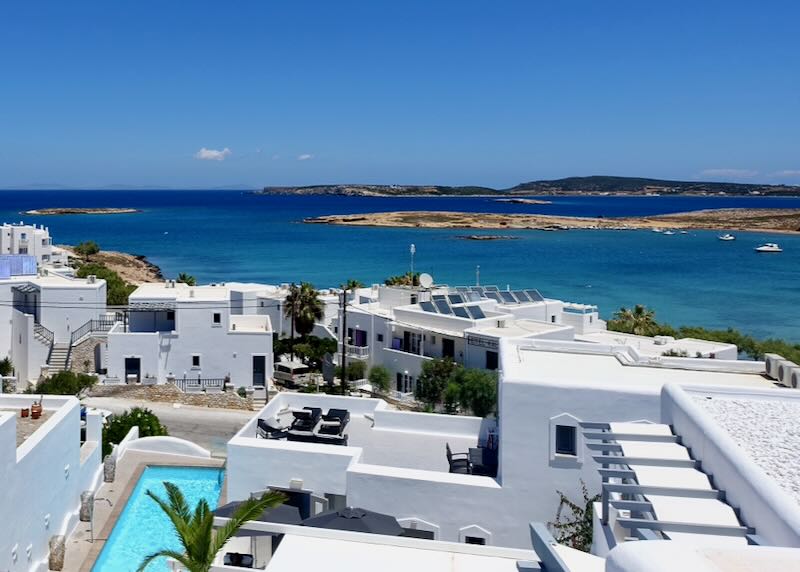 View overlooking boxy white hotel buildings to the blue sea