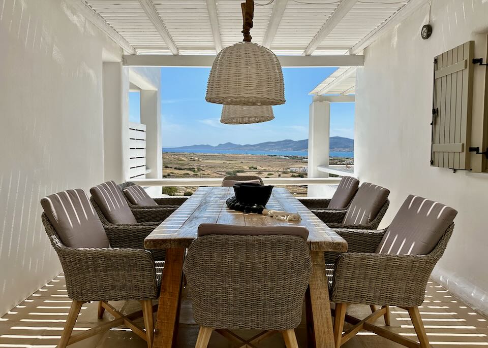 Covered outdoor dining table with a view to the sea