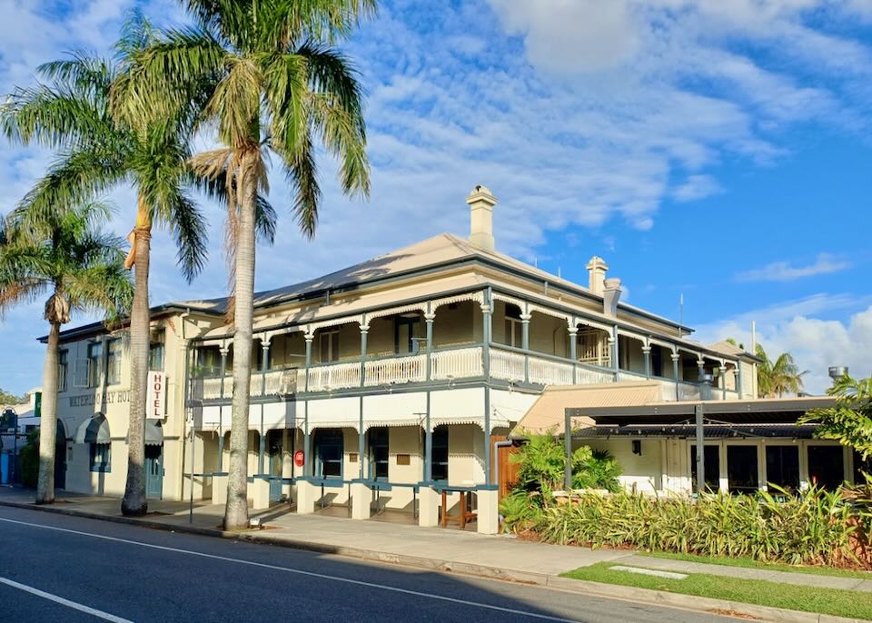 The exterior of a two-level historic hotel.