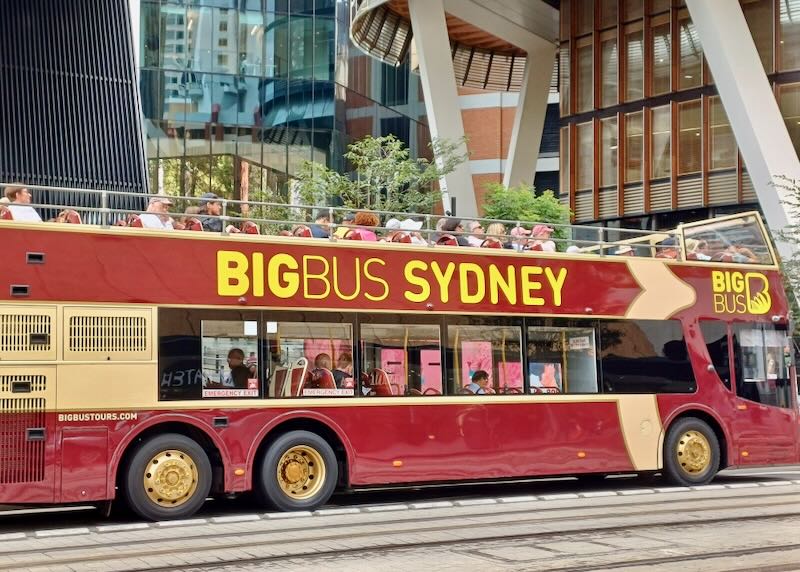 A red bus with yellow writing says, "Big bus Sydney."