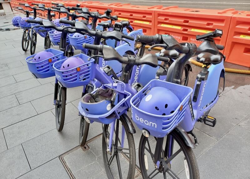 A row of purple e-bikes.