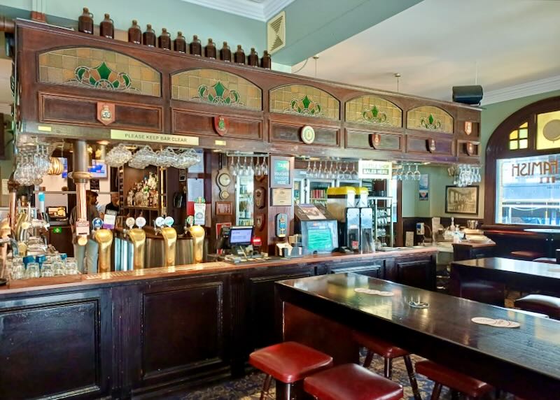 A wood-backed bar with stained-glass insets.