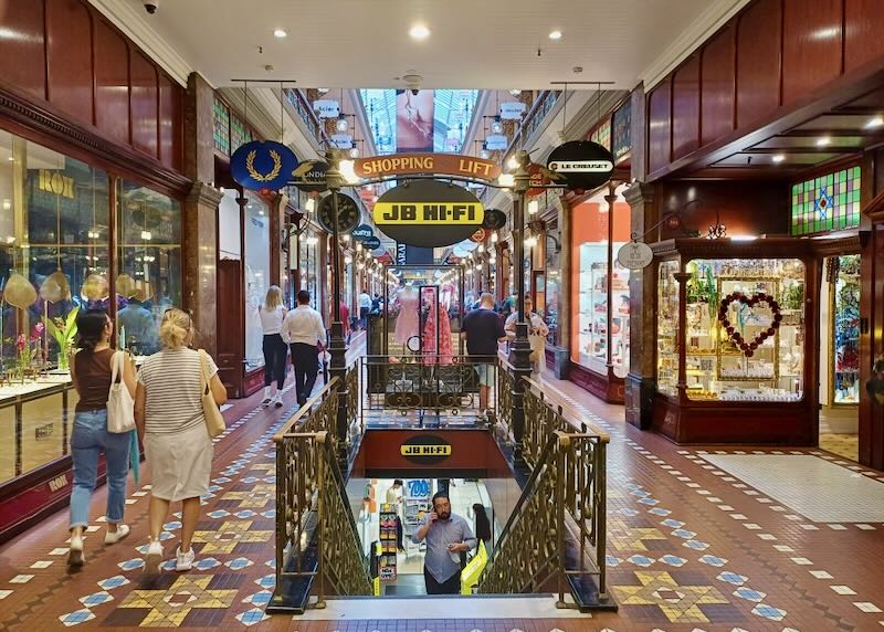 People walk in a shopping arcade.