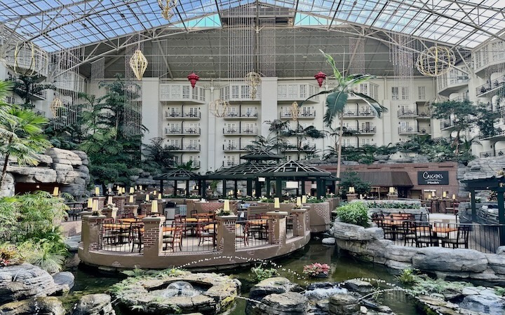 A restaurant set on a lagoon surrounded by gardens inside an enormous atrium at the Gaylord Opryland Resort in Nashville, Tennessee.