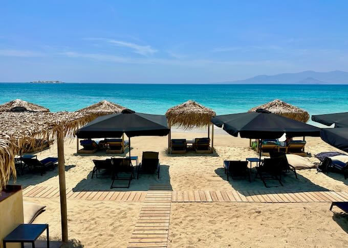 A row of beach beds on a golden sandy beach on a sunny day