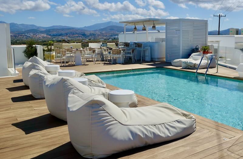 Rooftop sun deck with pool and bar on a sunny day.