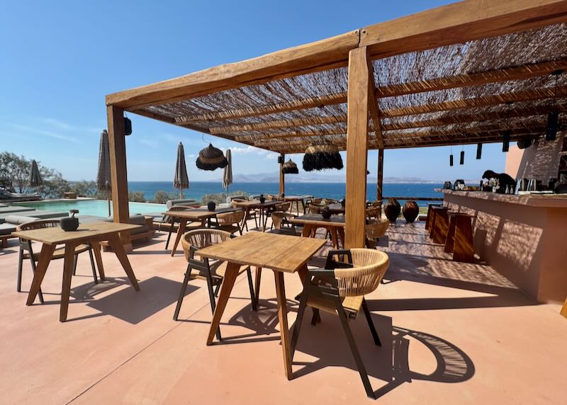 Luxury hotel pool terrace with bar, overlooking the sea