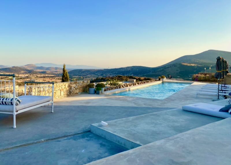 Stone sun terrace with swimming pool, overlooking the mountains at sunset