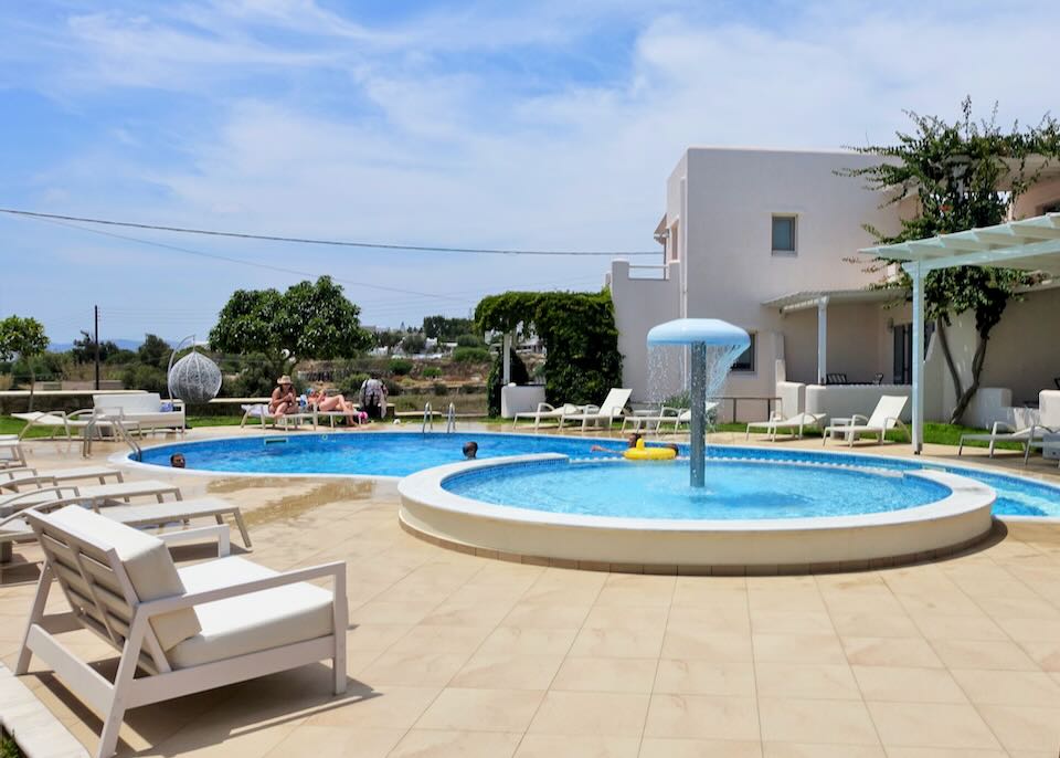 Hotel pool terrace with kids pool, surrounded by sun loungers