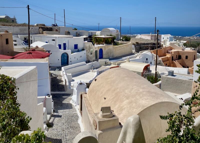 View over the winding narrow alleys of a traditional Greek village in Santorini