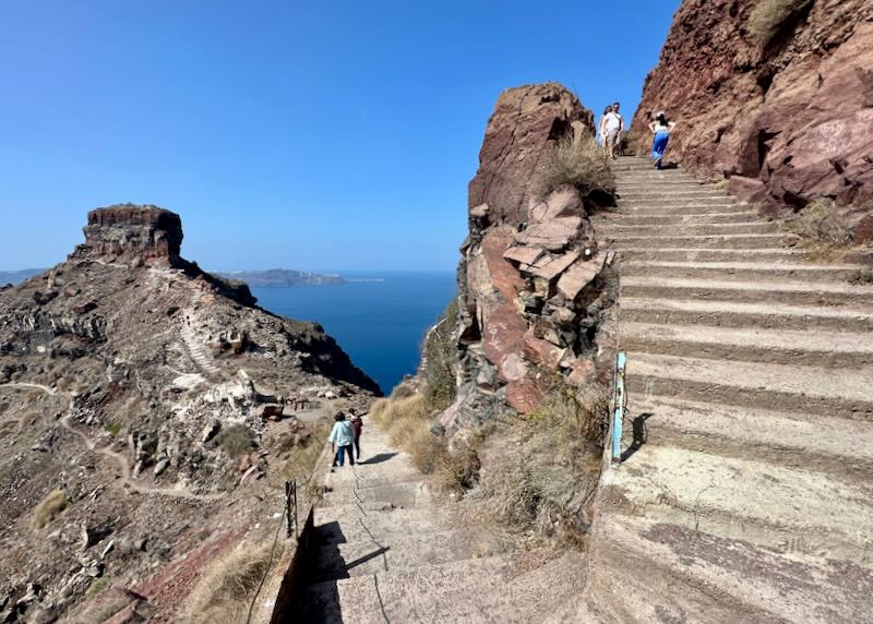 Steeo rocky stairway leading to a trail to Skaros Rock on Santorini.