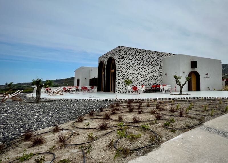 White boxy winery building on a rocky hillside.