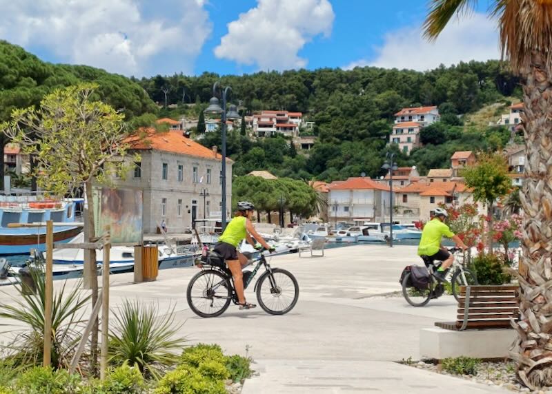 Two people cycle on the path.