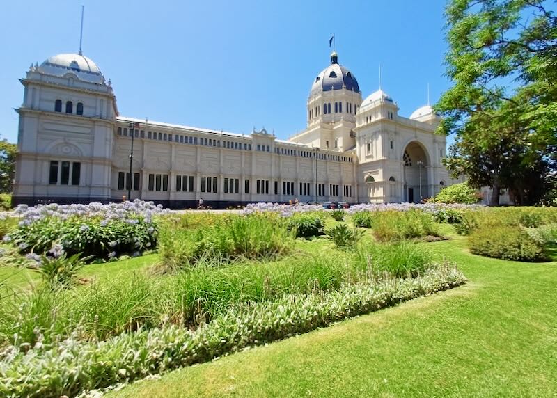 A long white building with a dark dome on top.