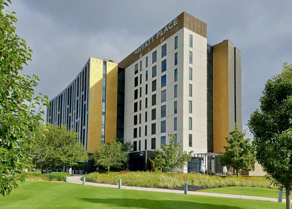 A tall hotel has gold tiles on a few sides.