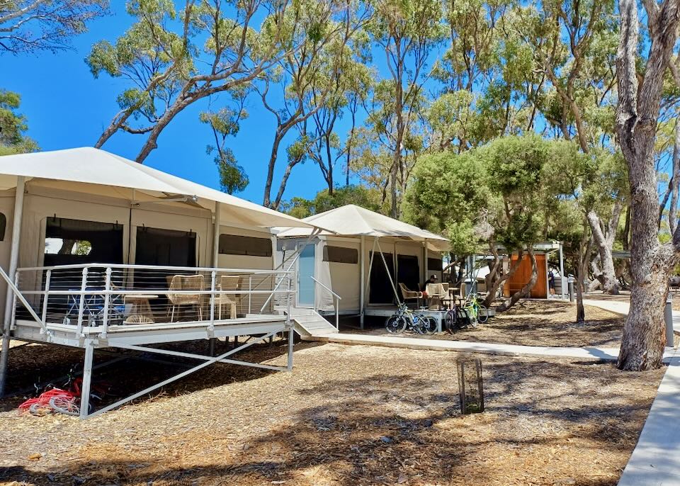 Tents, set off the ground, have deck areas and sidewalks.