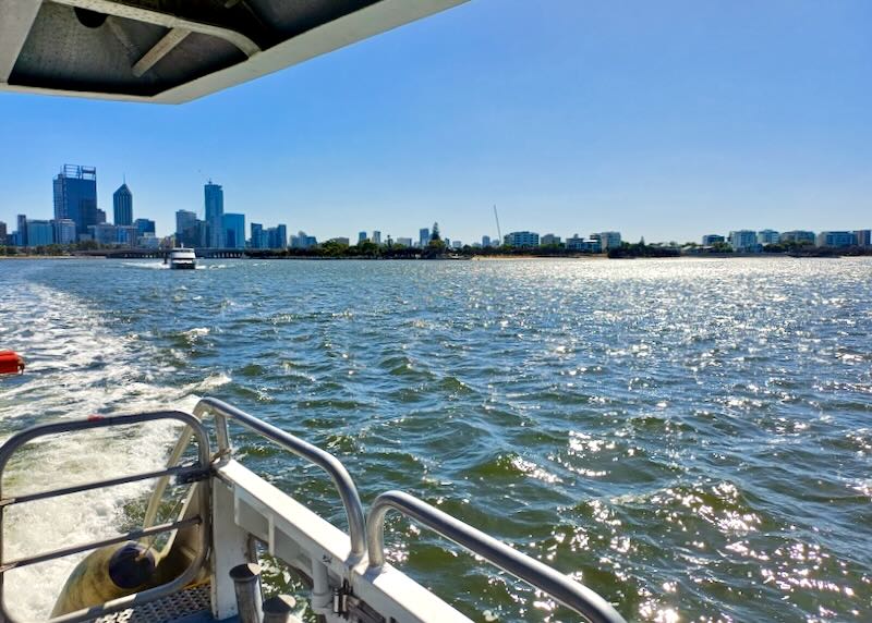 The view of the water out of the back of a ferry boat ride.