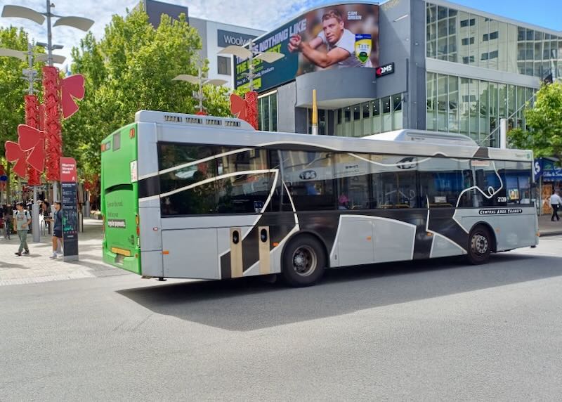 A city bus with an outline of a car down its side.