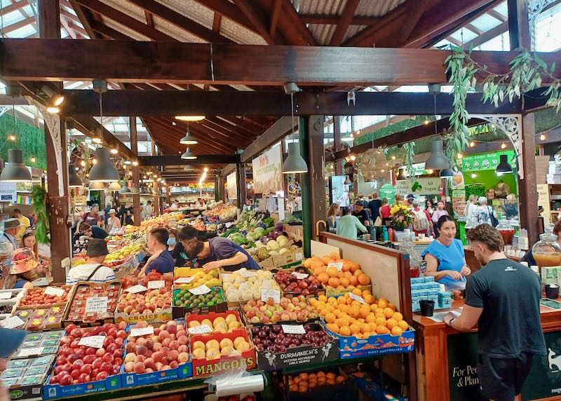 People shop at a produce market.