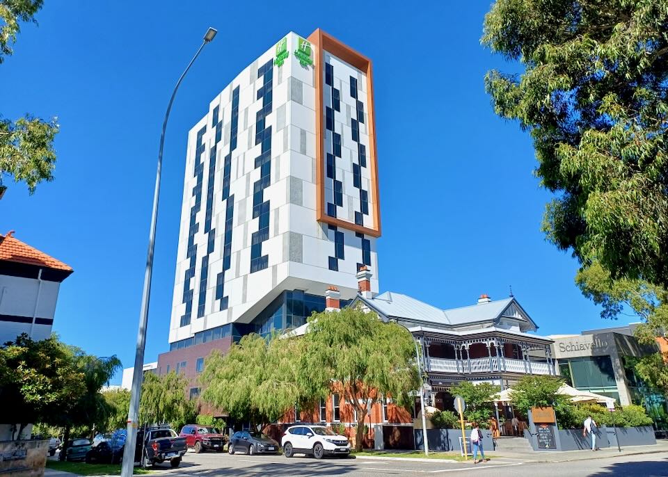 A tall white and gray checked building with an orange rectangle coming down the side.