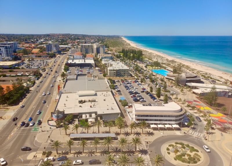 A view from high up of the ocean, shore, and town.