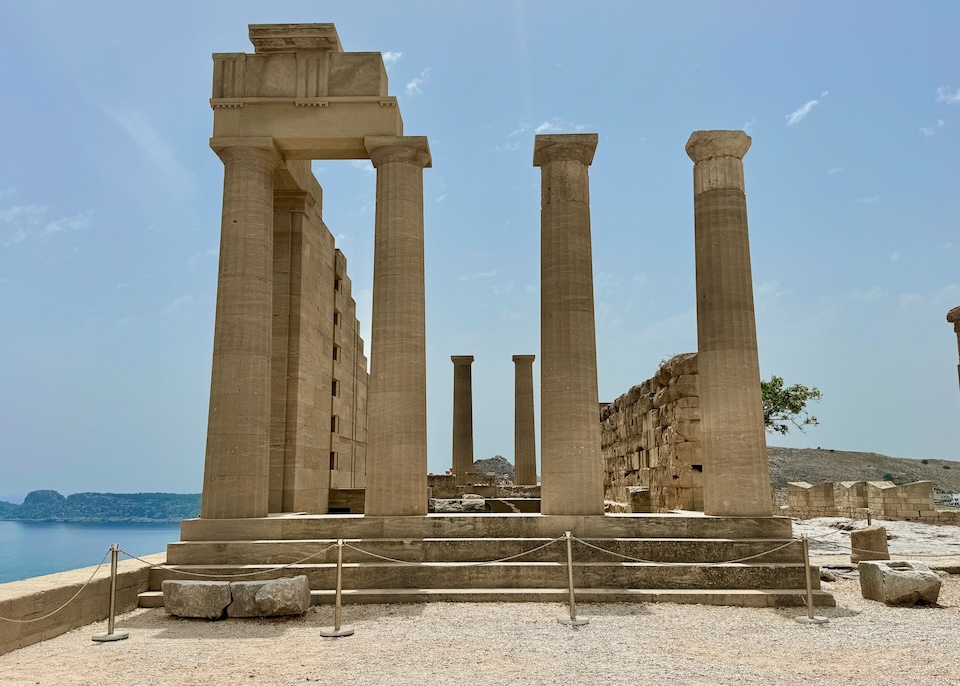 Upright columns and stone walls at the Acropolis in Lindos, Rhodes.