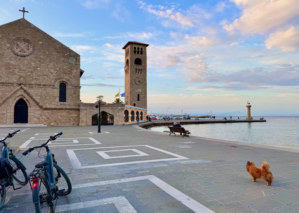 The Gothic-style Evangelismos Church and its bell tower on the harbor in Niohori, Rhodes.