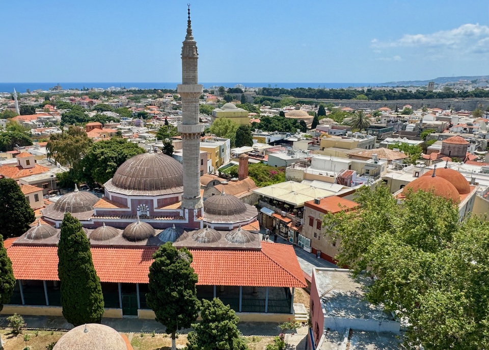 View overlooking Süleymaniye Mosque with its minaret and domes and Rhodes Old Town spreading out around it.