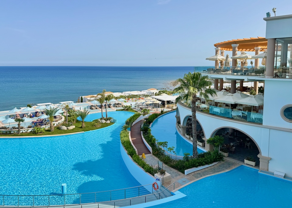 Two freeform pools set in tiers above the sea plus three floors of dining at Atrium Prestige resort near Lachania in Rhodes.