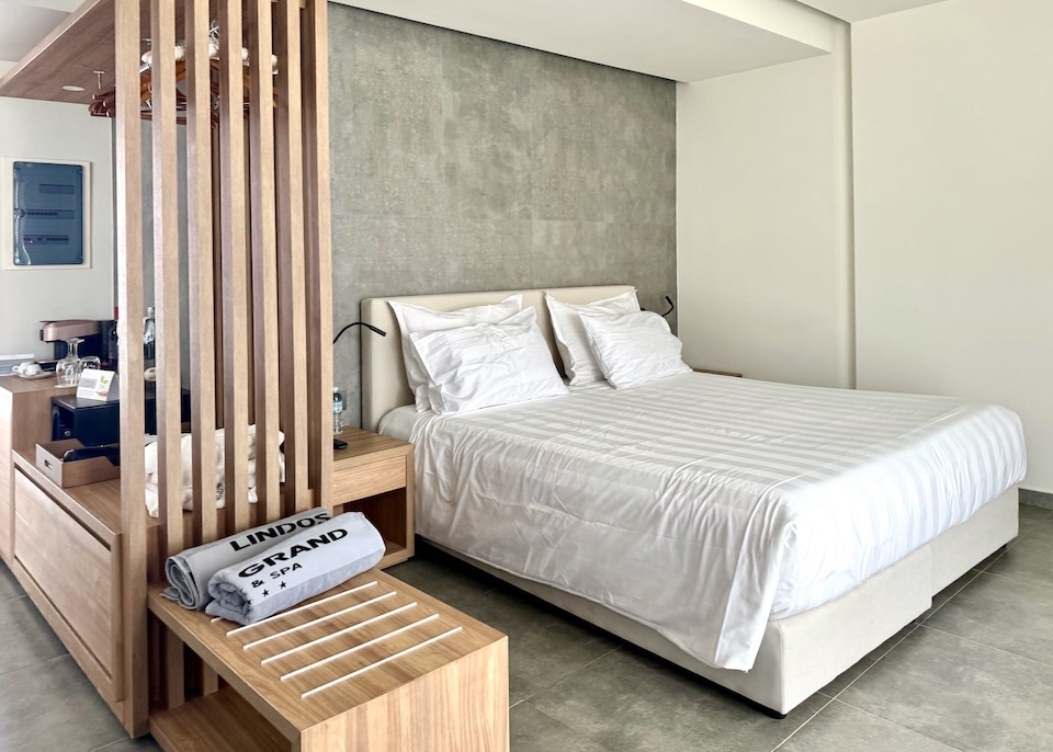 A minimalistic-style junior suite in white and neutral tones at Lindos Grand resort in Rhodes.