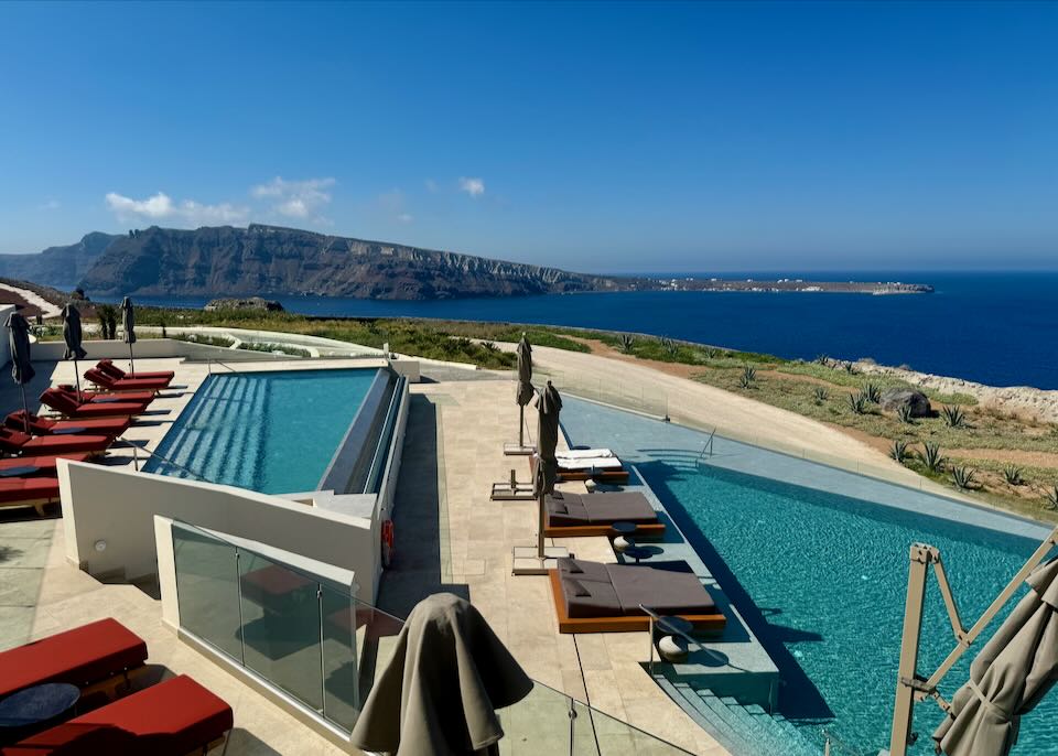 View over a hotel infinity-style swimming pool to the Aegean Sea