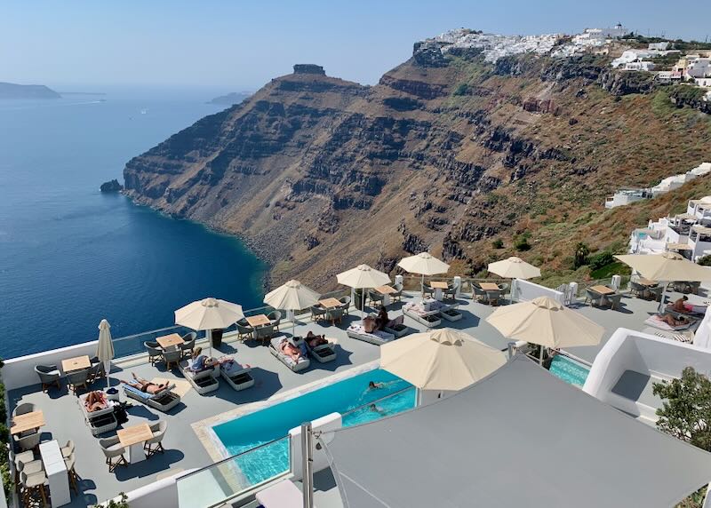 View over a swim terrace at a Santorini hotel.