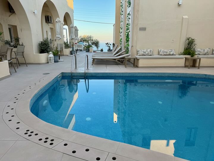 Sparkling swimming pool courtyard  in a Greek hotel.