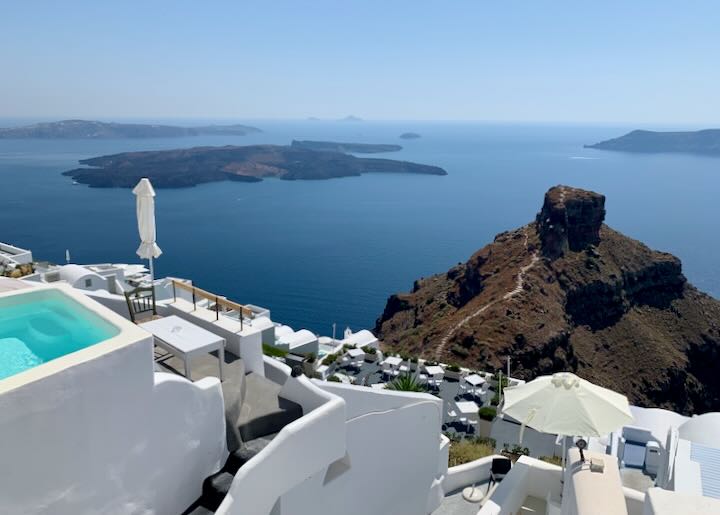 View over a cliffside hotel of the Santorini caldera and Skaros Rock. 