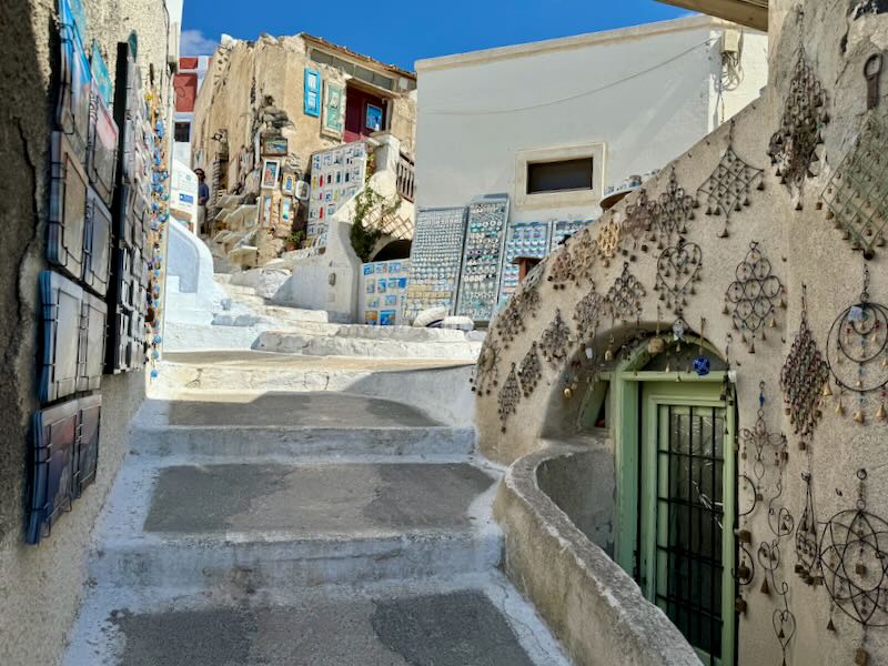 A steep and narrow lane lined with souvenirs. 