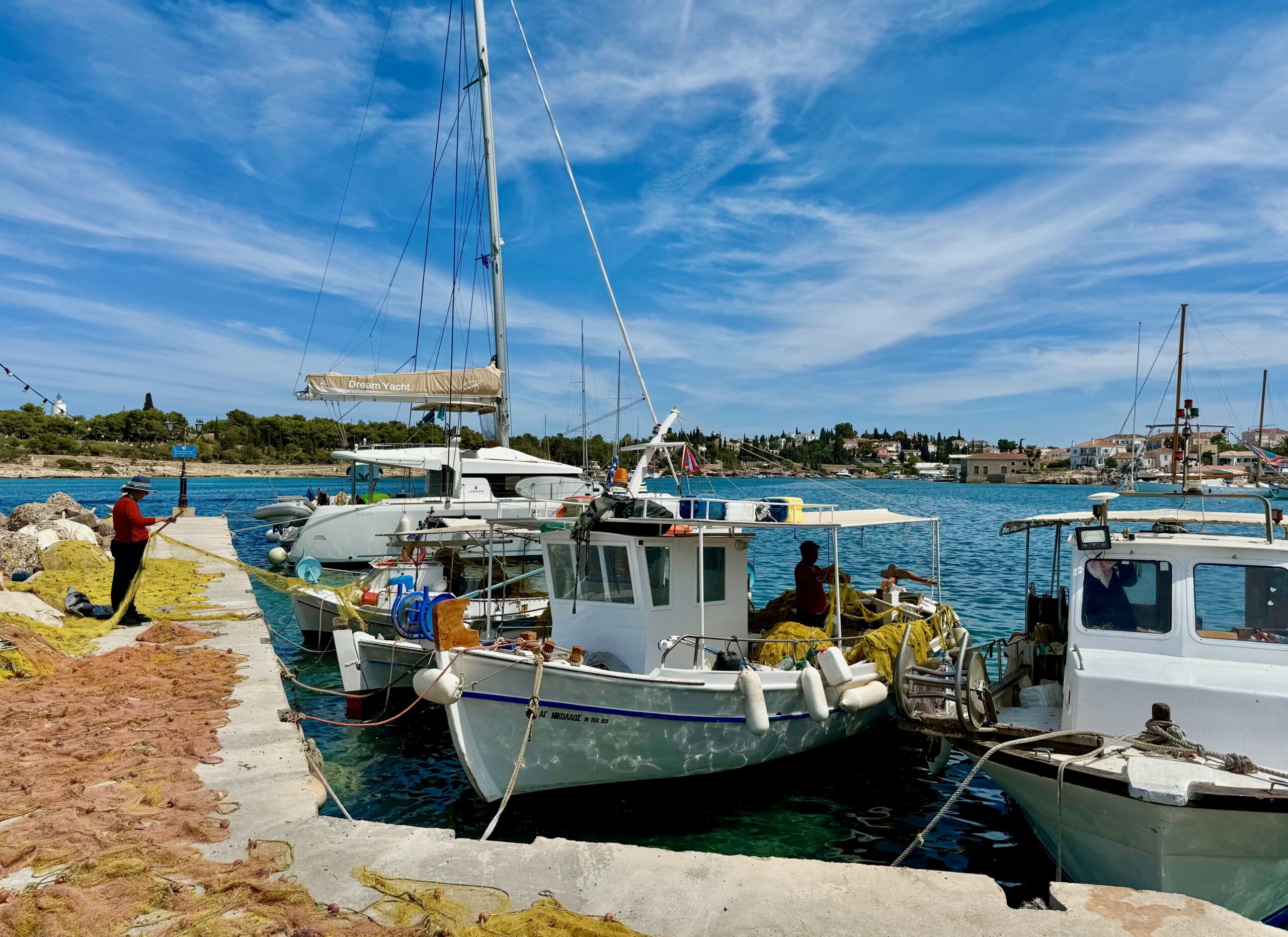 Fishermen winding their nets back up at the end of the day in the Old Harbor of Spetses.