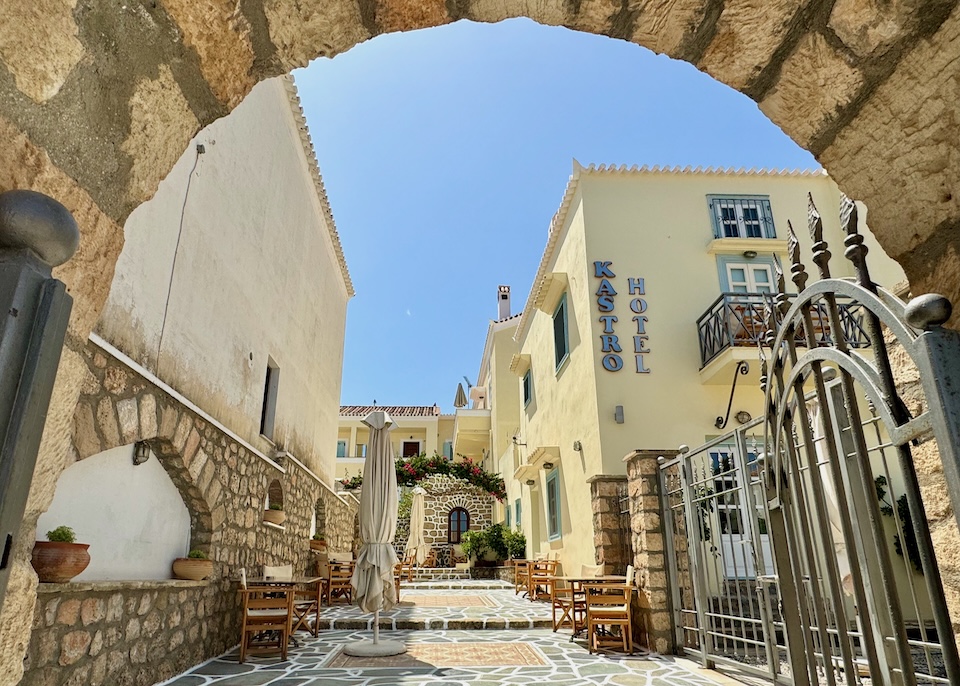 Looking through the arched gate onto the courtyard patio of Hotel Kastro in Spetses.