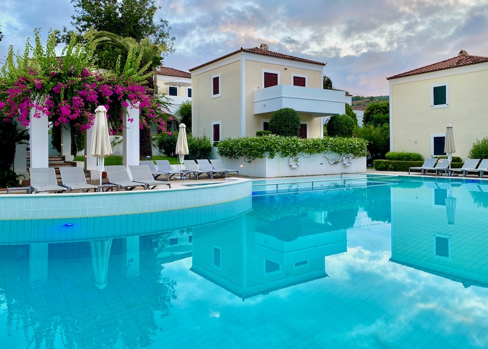 A freeform pool with sunbeds n a dais at Nissia hotel in Spetses.