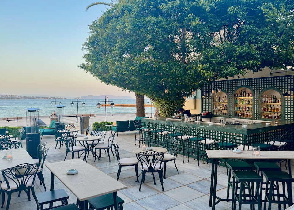 An upscale, open-air cocktail lounge with a view of the sea at Poseidonion Grand Hotel in Spetses.