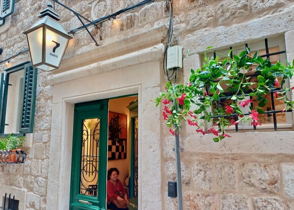 A lantern hangs over a green door.