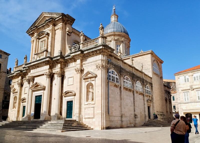 An old two-level cathedral made of tan stones.