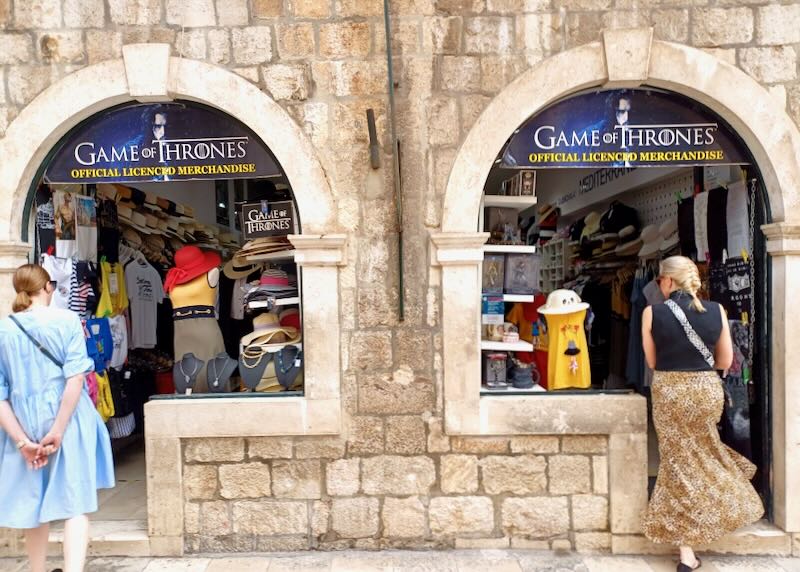 Women walk into a store selling merchandise from the tv show, Game of Thrones.