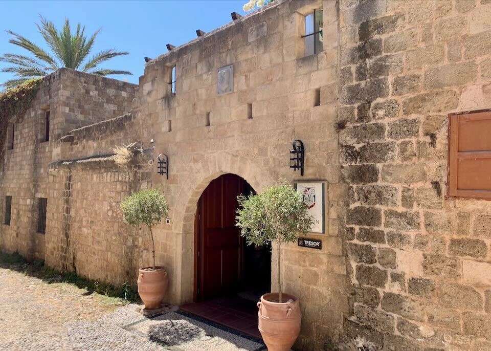 Outside the medieval stone facade at Avalon Boutique Hotel in Rhodes.