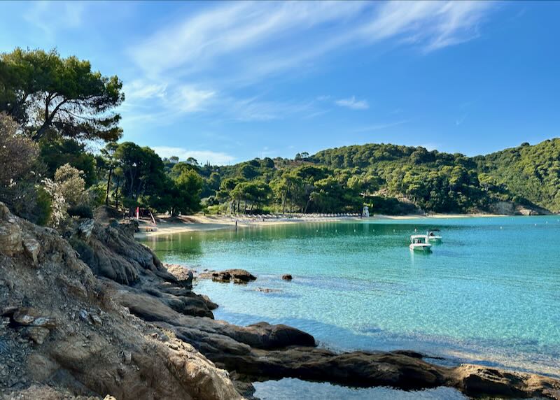 Rocky cove with a sandy beach and crystal blue water