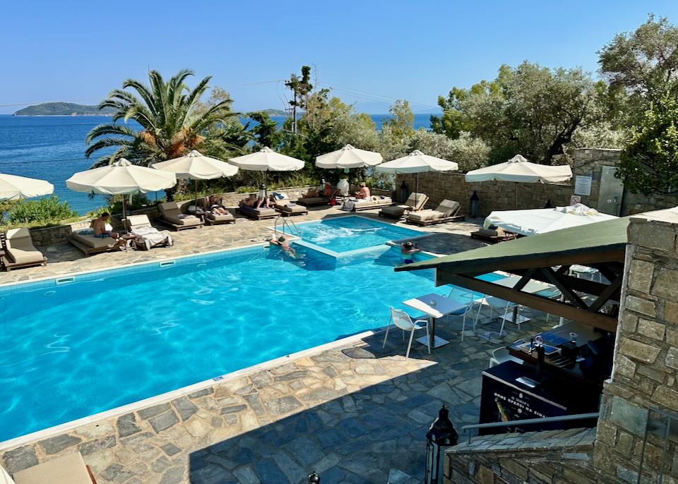 View from above of a hotel pool deck with sun loungers.