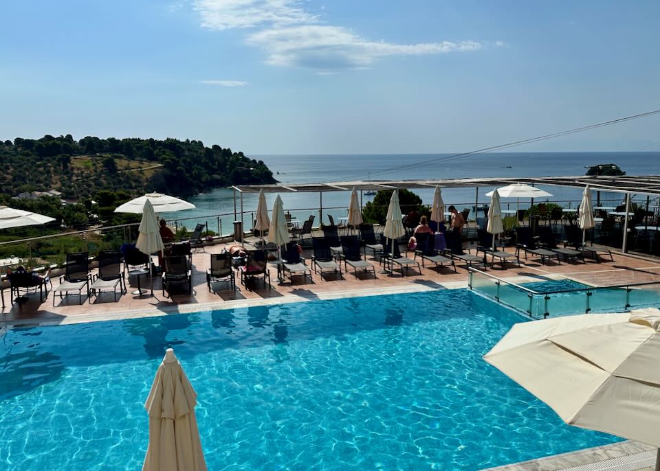 View over a hotel swimming pool to the sea.