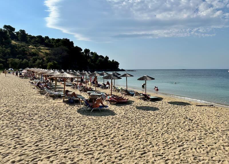 Rows of sun beds in the sand of Troulos Beach in Skiathos, Greece