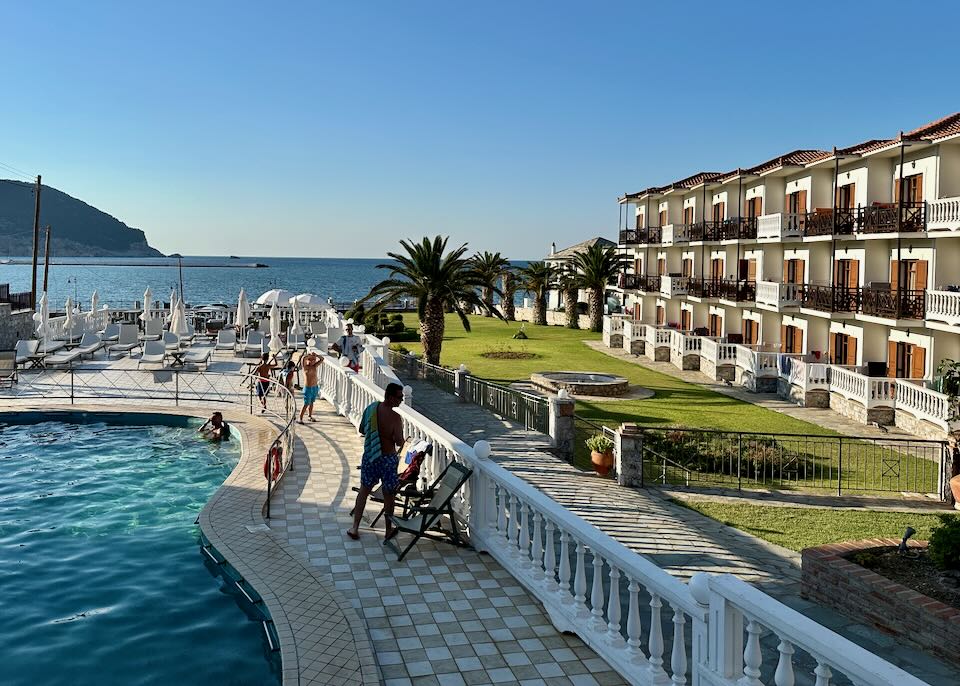 Outdoor hotel pool next to a green lawn.