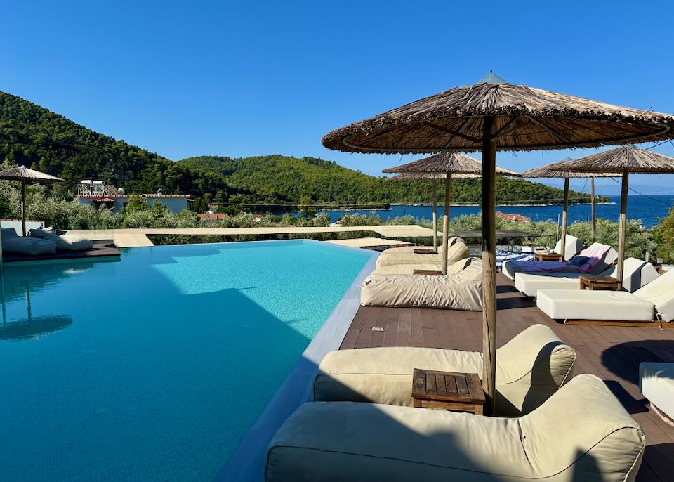 Puffy sun beds surround a hotel swimming pool. 