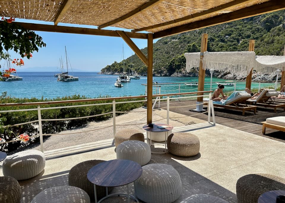 Shaded seating area in a beach bar overlooking the sea